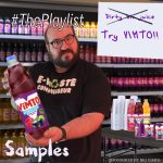 #ThePlaylist The artwork for this week's edition of #ThePlaylist. It features me, a bearded man, offering a bottle of Vimto to the camera. Behind me, a table covered in other bottles of Vimto, offering samples.